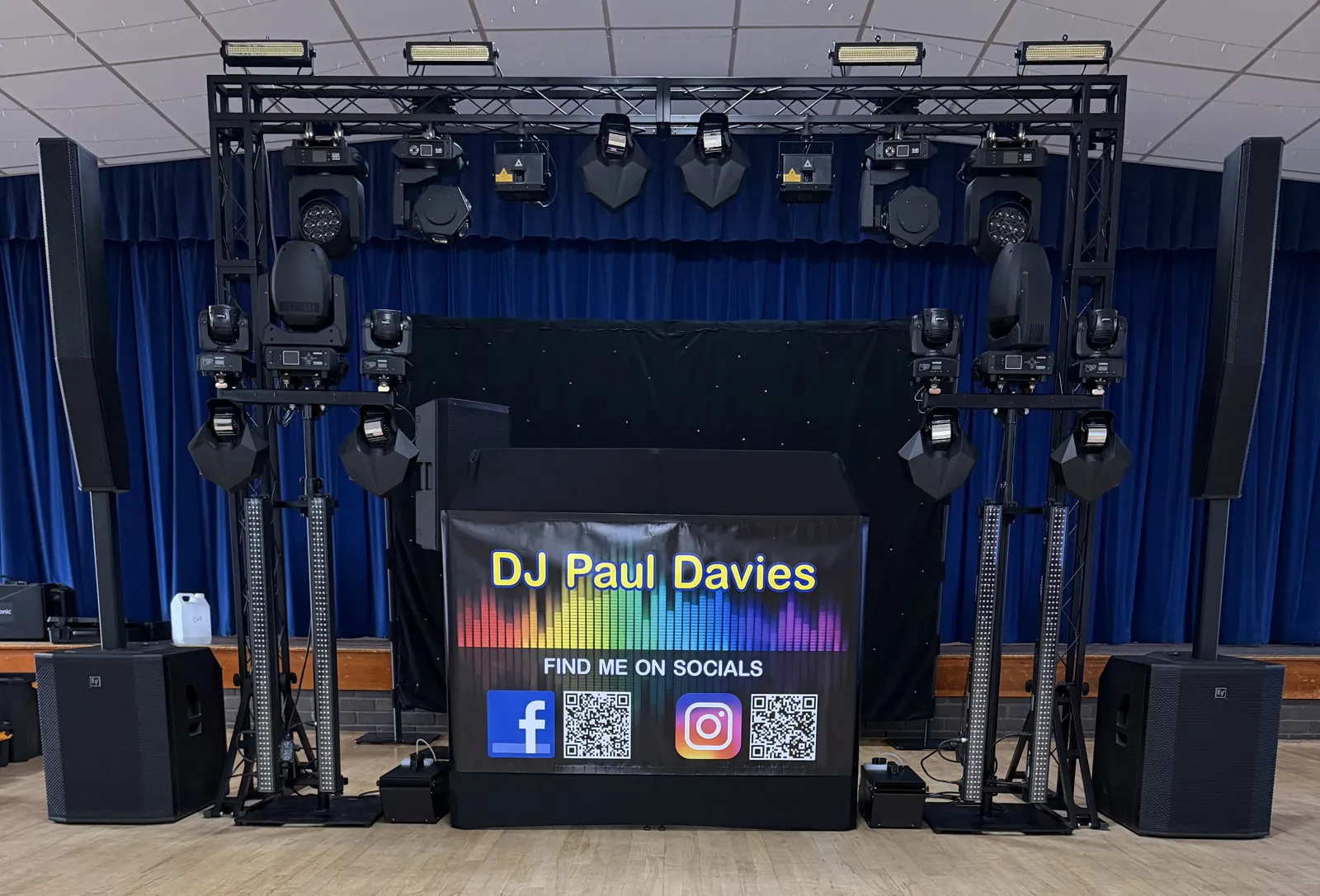 DJ Paul Davies wedding DJ setup with truss, moving head lighting, column array sound system and star cloth booth